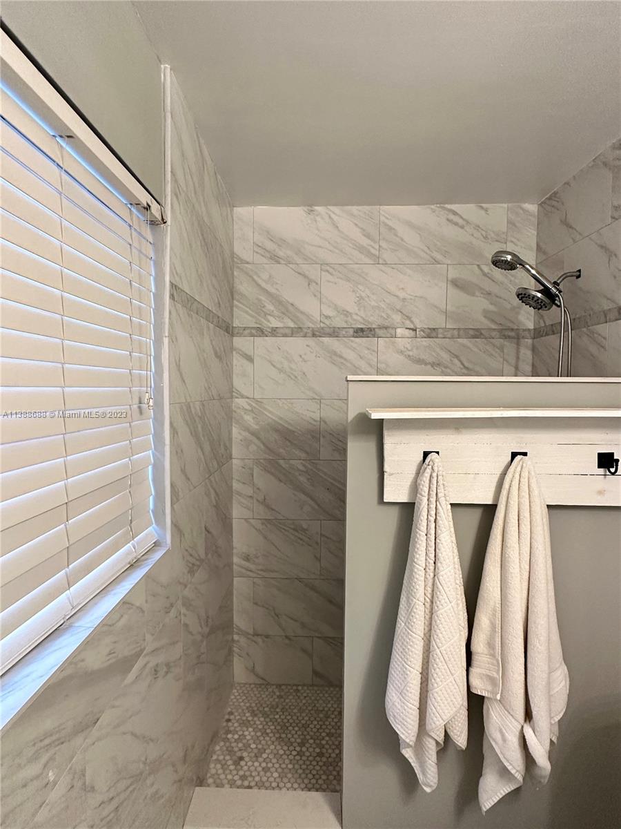 300 E Circle Jupiter, FL 33458 - Photo 18 of 28 a view of walk in closet with clothes and white walls