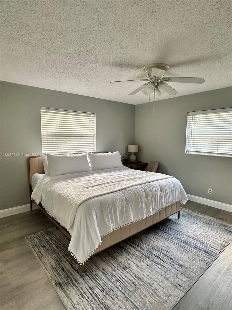 300 E Circle Jupiter, FL 33458 - Photo 19 of 28 a bedroom with a bed and window