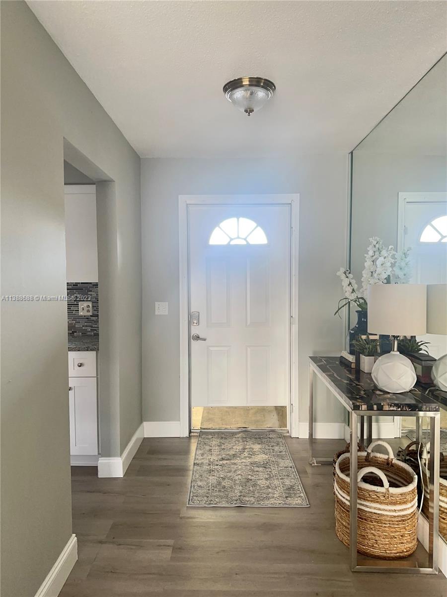 300 E Circle Jupiter, FL 33458 - Photo 2 of 28 a room with furniture and a wooden floor