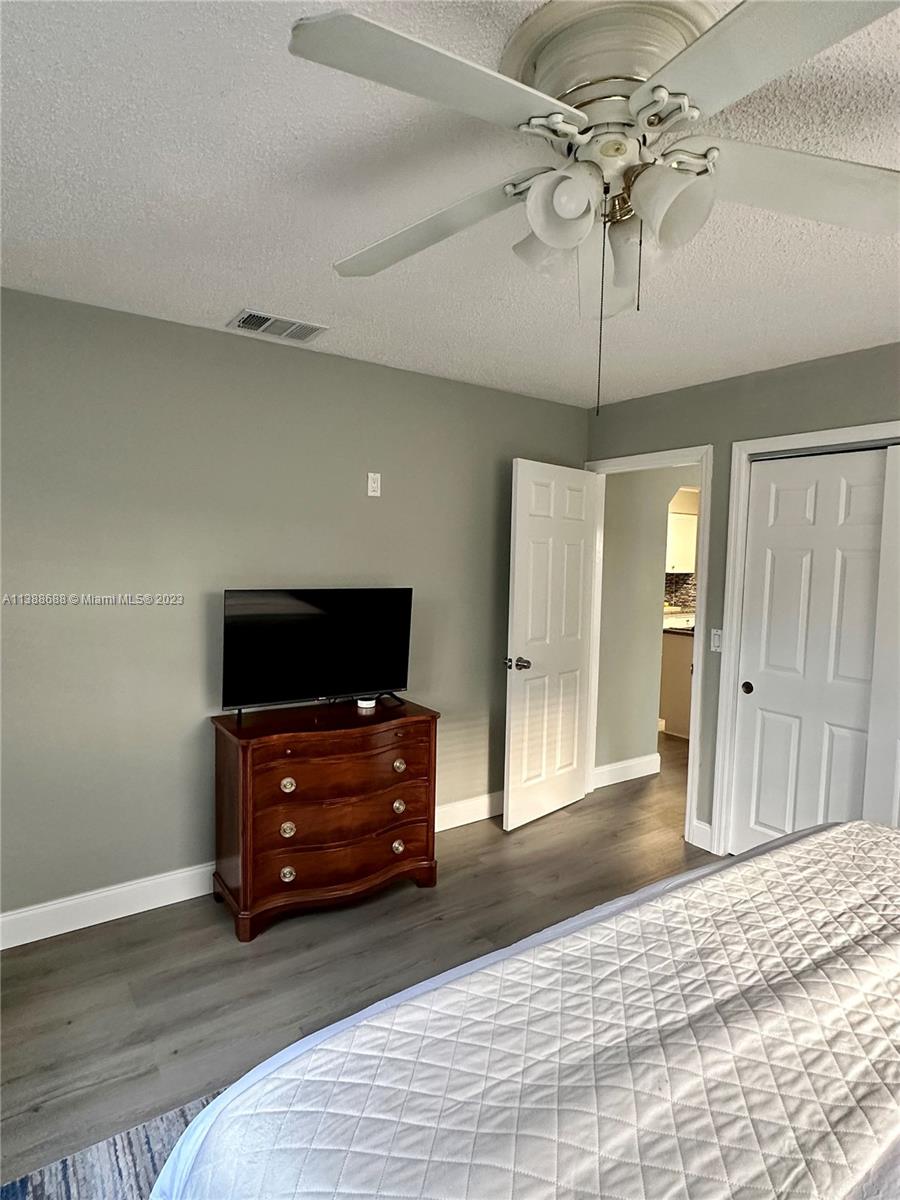300 E Circle Jupiter, FL 33458 - Photo 23 of 28 a living room with furniture and a flat screen tv