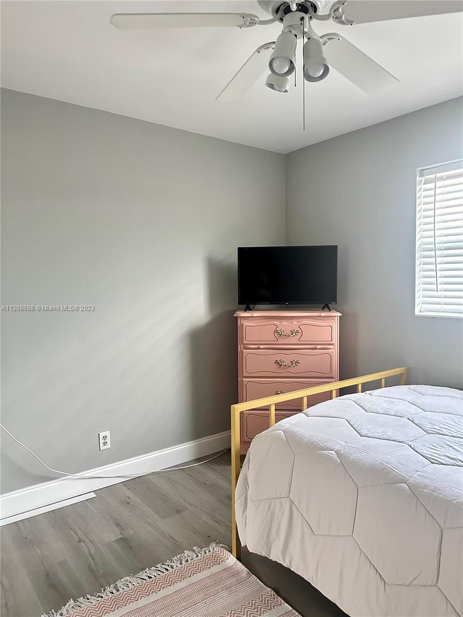 300 E Circle Jupiter, FL 33458 - Photo 24 of 28 a bedroom with a bed and a flat screen tv