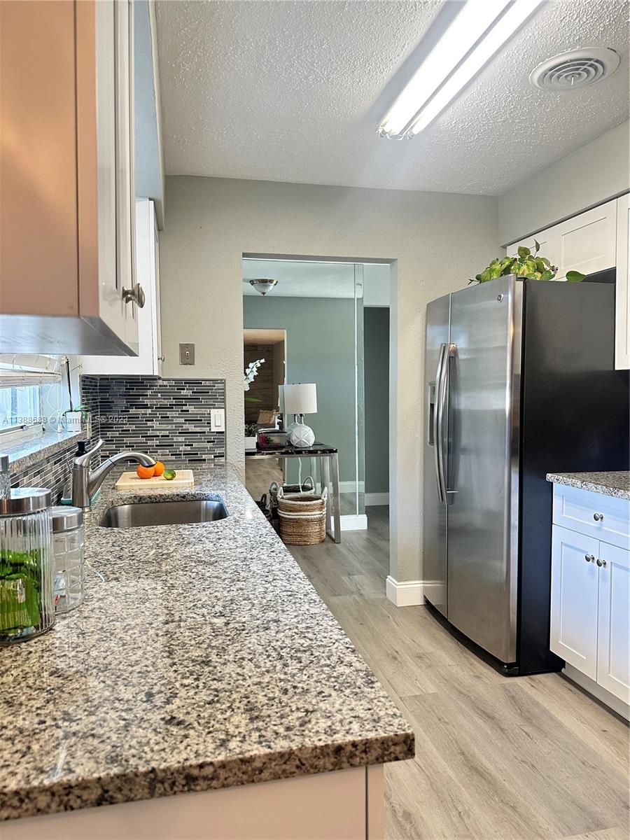 300 E Circle Jupiter, FL 33458 - Photo 7 of 28 a kitchen with a refrigerator sink and stove
