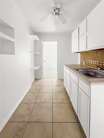 a kitchen with a sink and cabinets