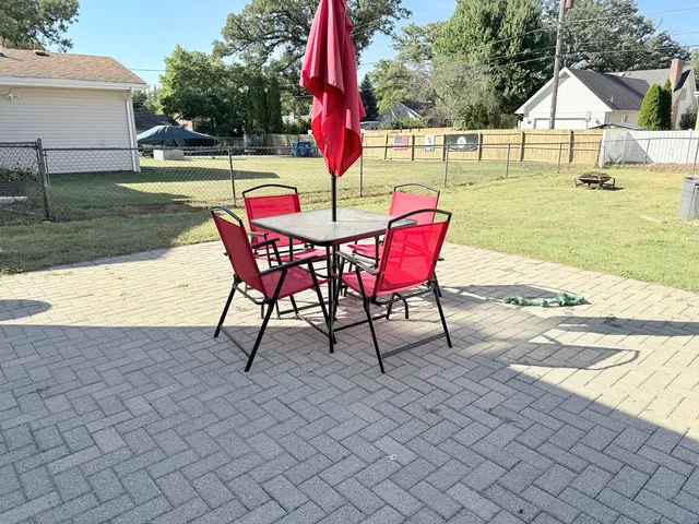 a view of a house with backyard and sitting area