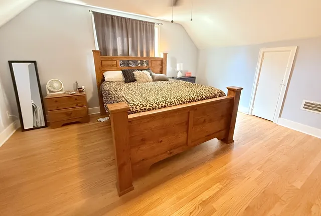 a living room with a couch and a dresser next to a window