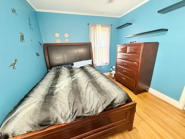 a bedroom with a bed and a dresser
