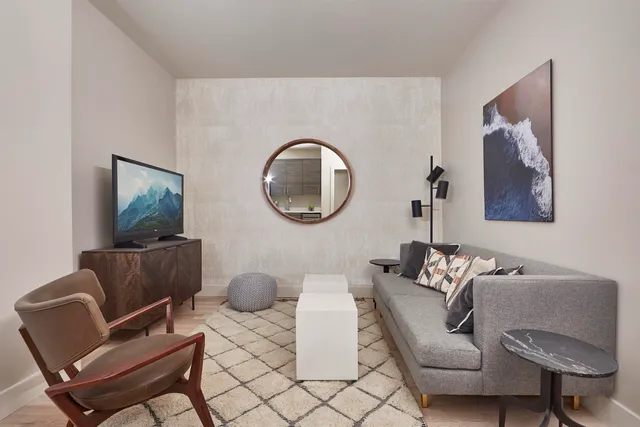 a living room with furniture and a wooden floor