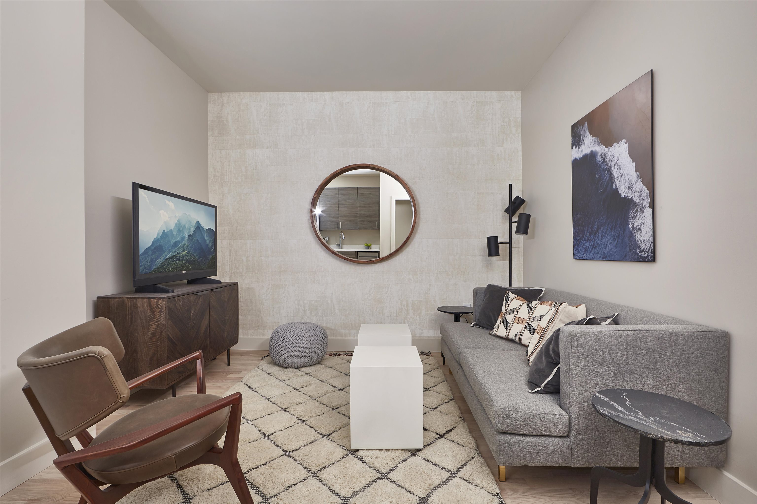 a living room with furniture and a wooden floor