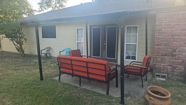 a wooden bench sitting in front of a house