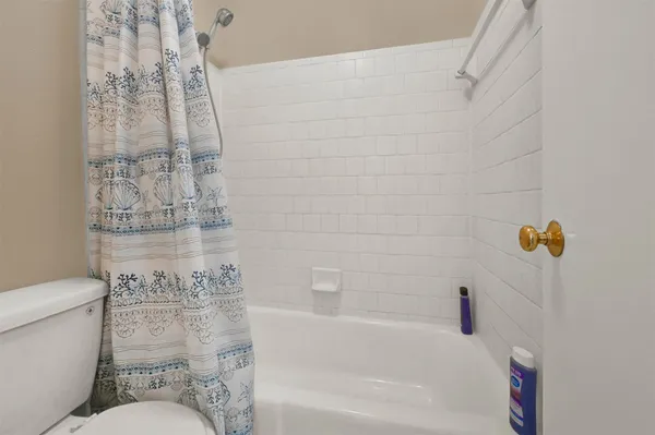 a bathroom with a toilet and shower