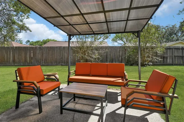 a backyard of a house with table and chairs