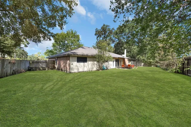 a view of a house with a backyard