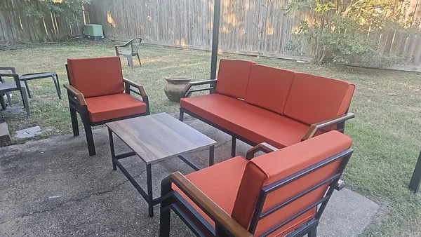 a outdoor sitting area with furniture and wooden deck