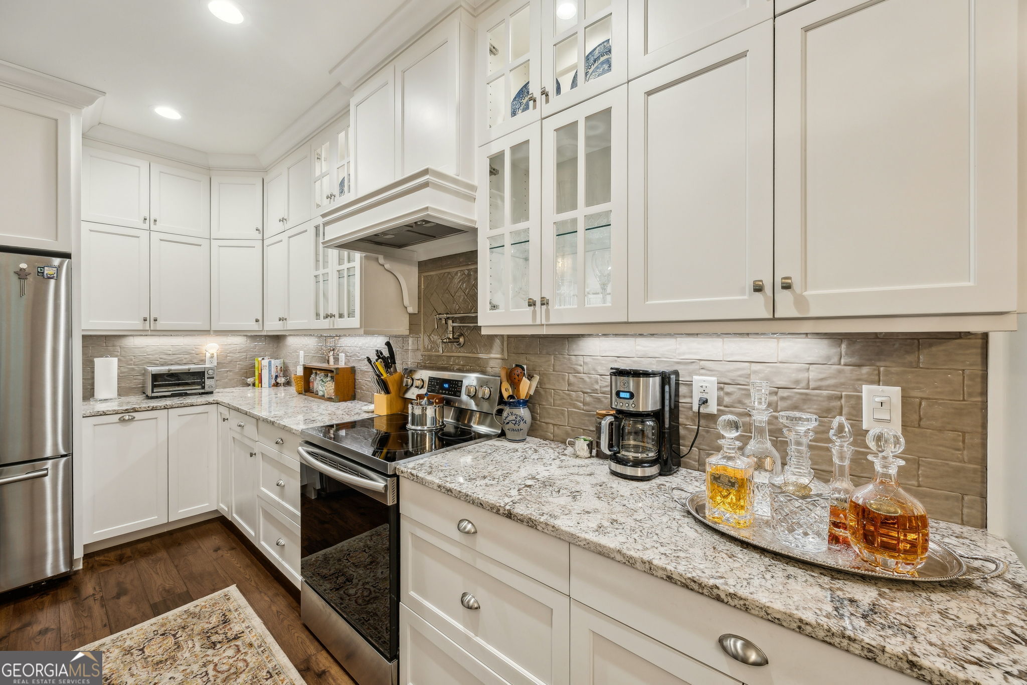 105 Spartina Court St. Marys, GA 31558 - Photo 21 of 95 a kitchen with stainless steel appliances granite countertop a stove a sink and white cabinets