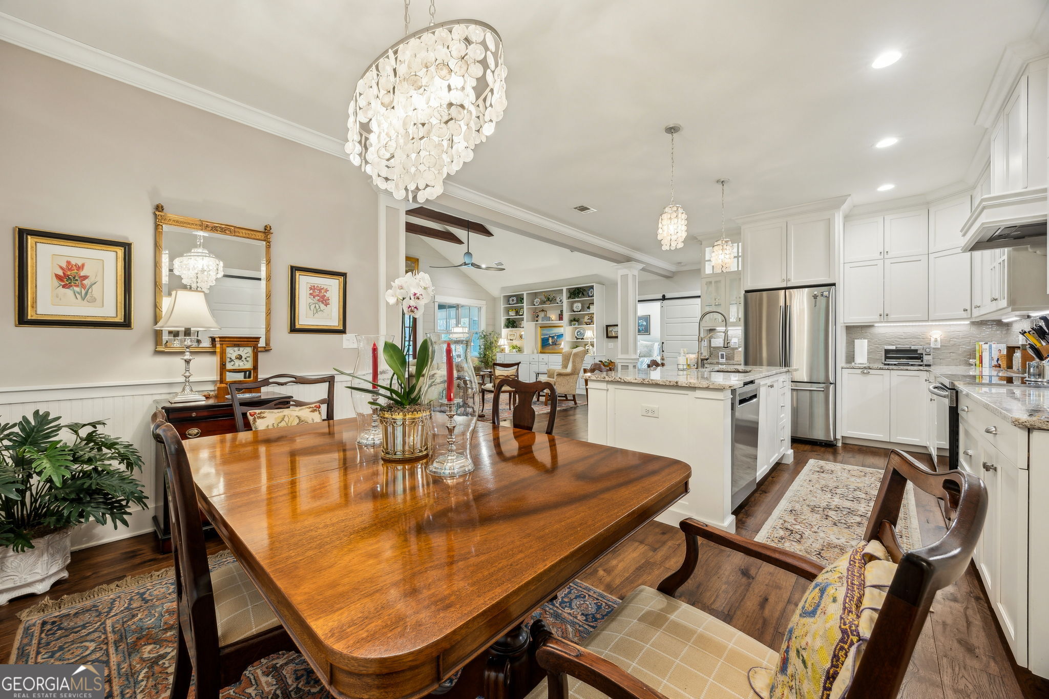 105 Spartina Court St. Marys, GA 31558 - Photo 26 of 95 a dining room with wooden floor a chandelier a wooden table and chairs