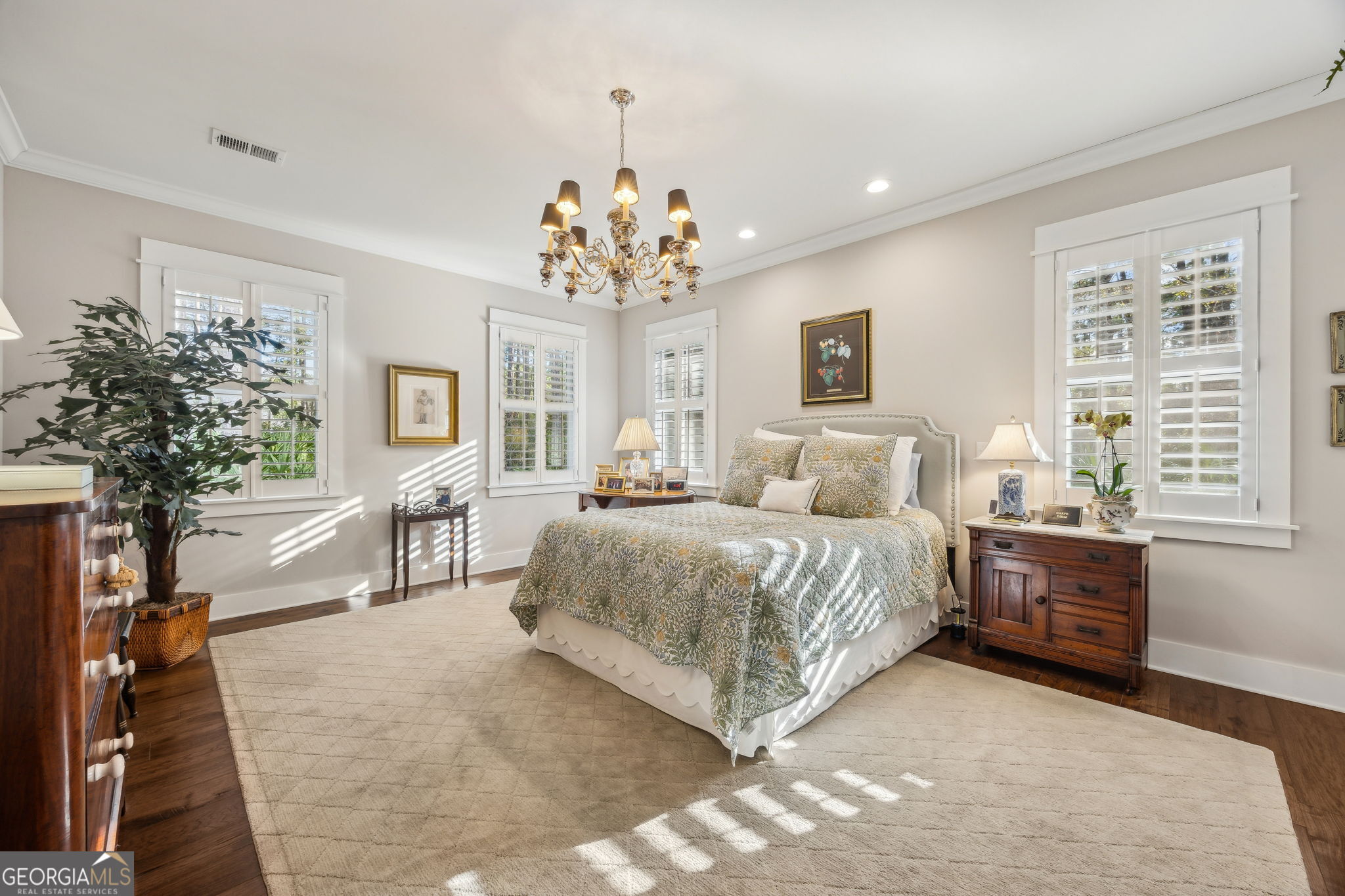 105 Spartina Court St. Marys, GA 31558 - Photo 32 of 95 a spacious bedroom with a large bed and a chandelier