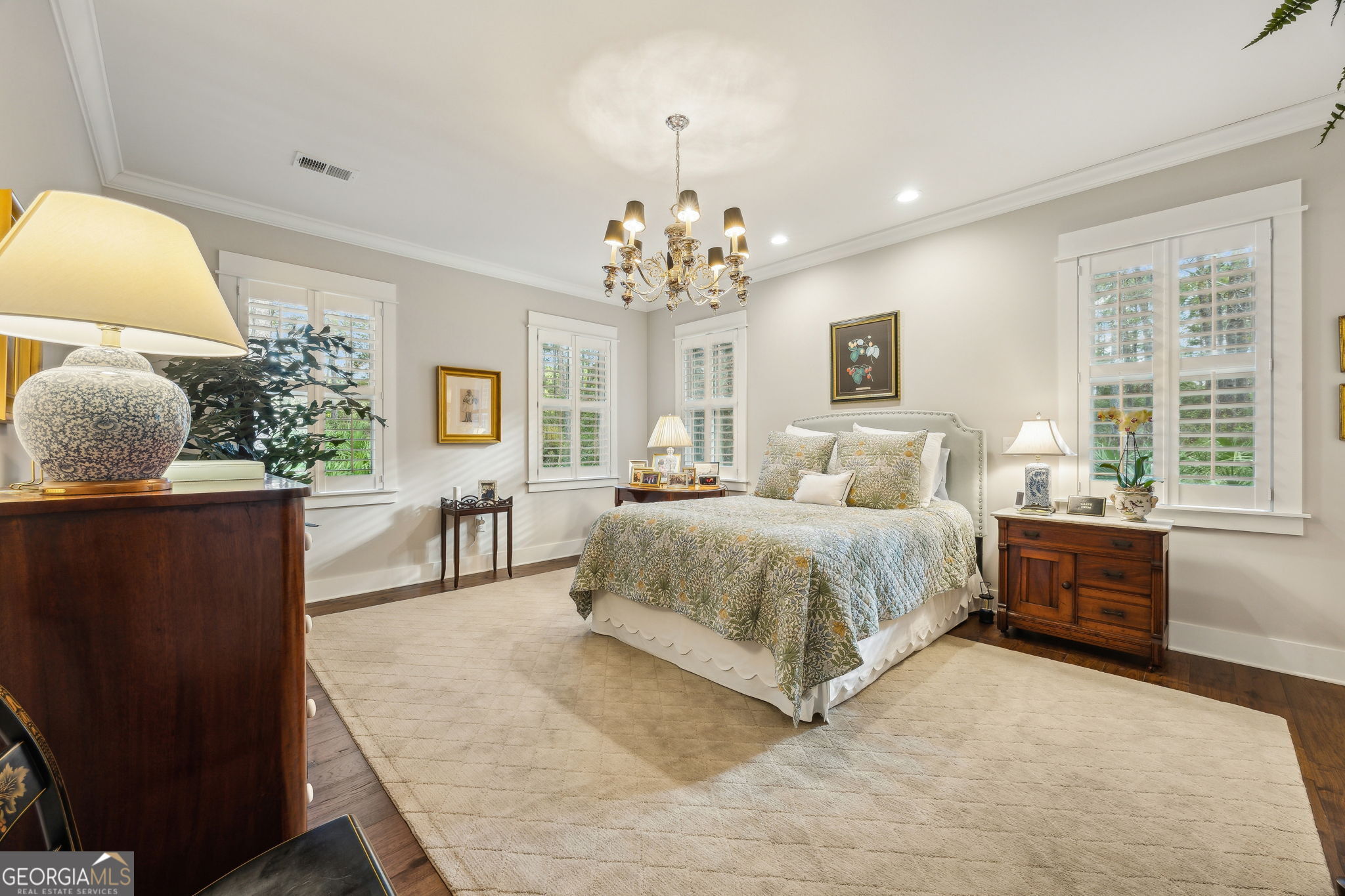 105 Spartina Court St. Marys, GA 31558 - Photo 33 of 95 a spacious bedroom with a large bed and a chandelier