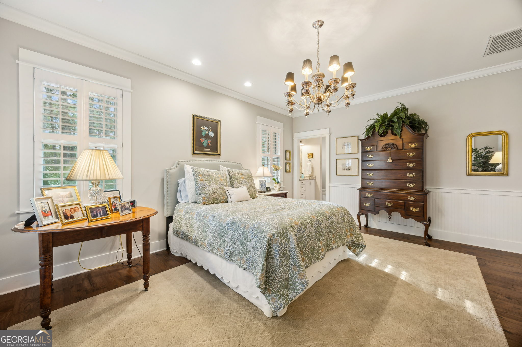 105 Spartina Court St. Marys, GA 31558 - Photo 35 of 95 a spacious bedroom with a bed and a chandelier
