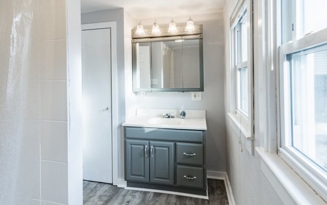 407 Maple Street Marengo, IL 60152 - Photo 18 of 24 a bathroom with a granite countertop sink and a mirror