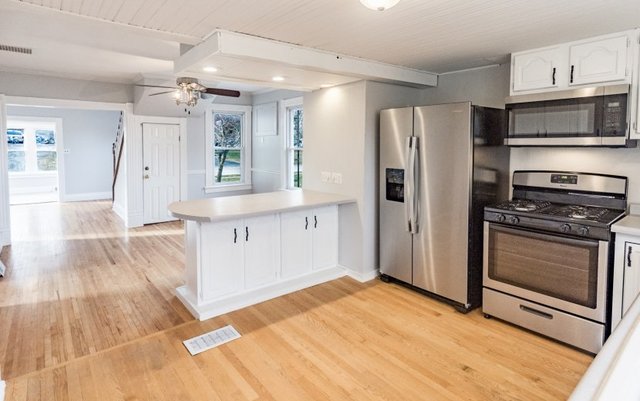 407 Maple Street Marengo, IL 60152 - Photo 4 of 24 a kitchen with stainless steel appliances granite countertop a refrigerator and a stove top oven