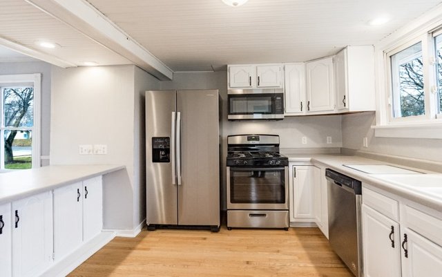 407 Maple Street Marengo, IL 60152 - Photo 5 of 24 a kitchen with stainless steel appliances granite countertop a refrigerator sink and stove