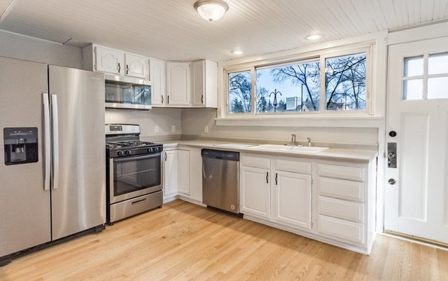 407 Maple Street Marengo, IL 60152 - Photo 6 of 24 a kitchen with white cabinets and white appliances