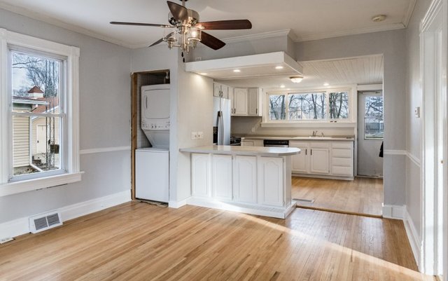 407 Maple Street Marengo, IL 60152 - Photo 7 of 24 a kitchen with granite countertop a stove a sink and a refrigerator