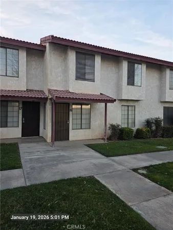 a front view of a house with a garden and yard