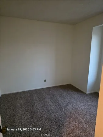 a view of a room with a ceiling fan and window