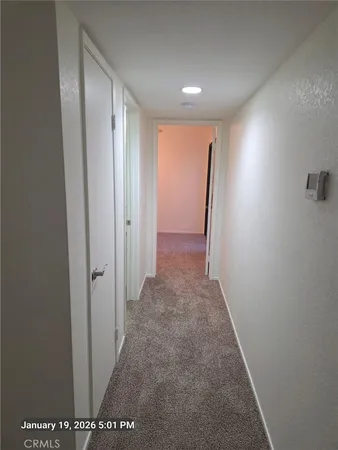 a view of an empty room and wooden floor