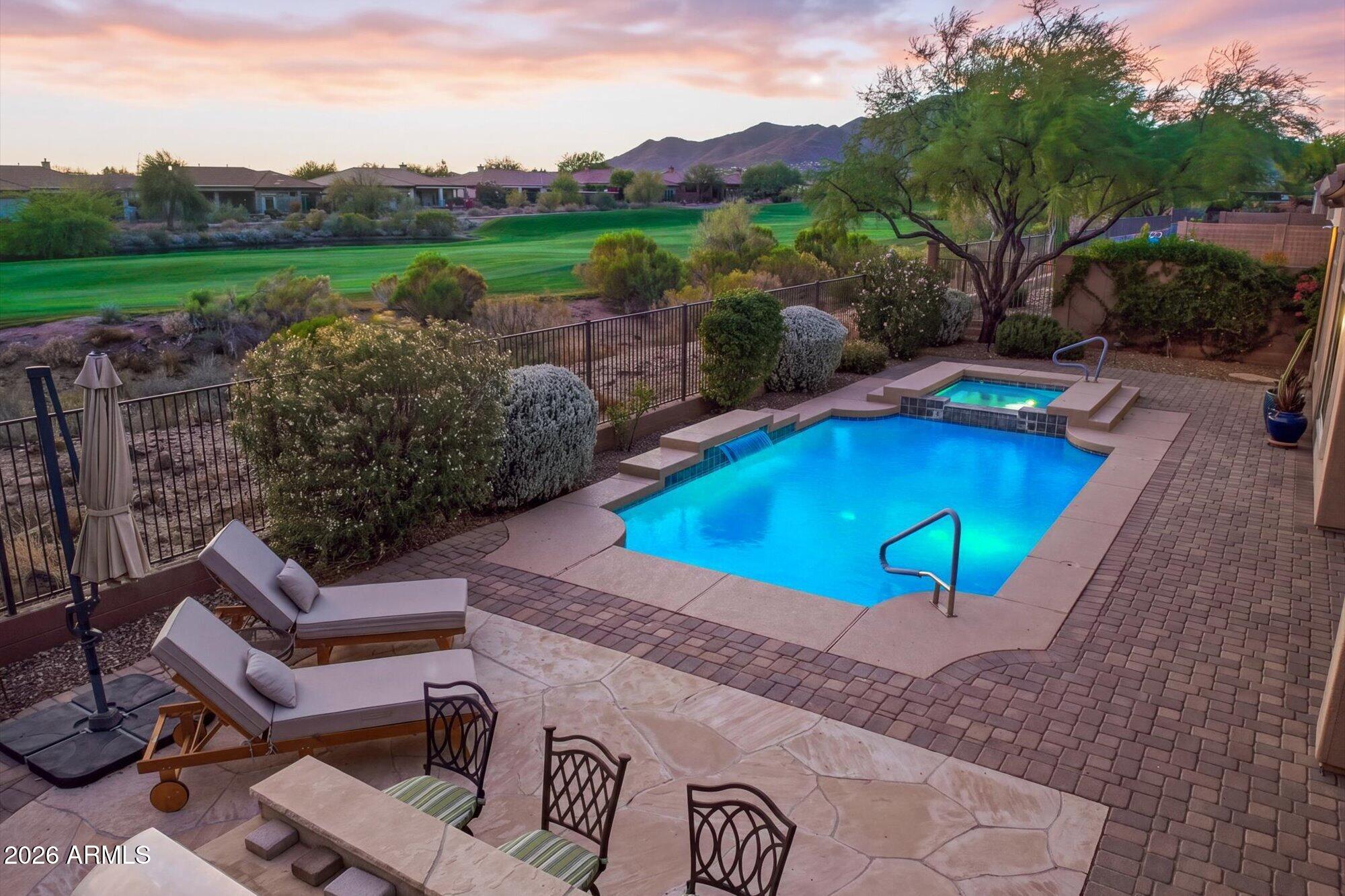 40322 North Hawk Ridge Trail Anthem, AZ 85086 - Photo 1 of 63 a view of a swimming pool with a patio and garden