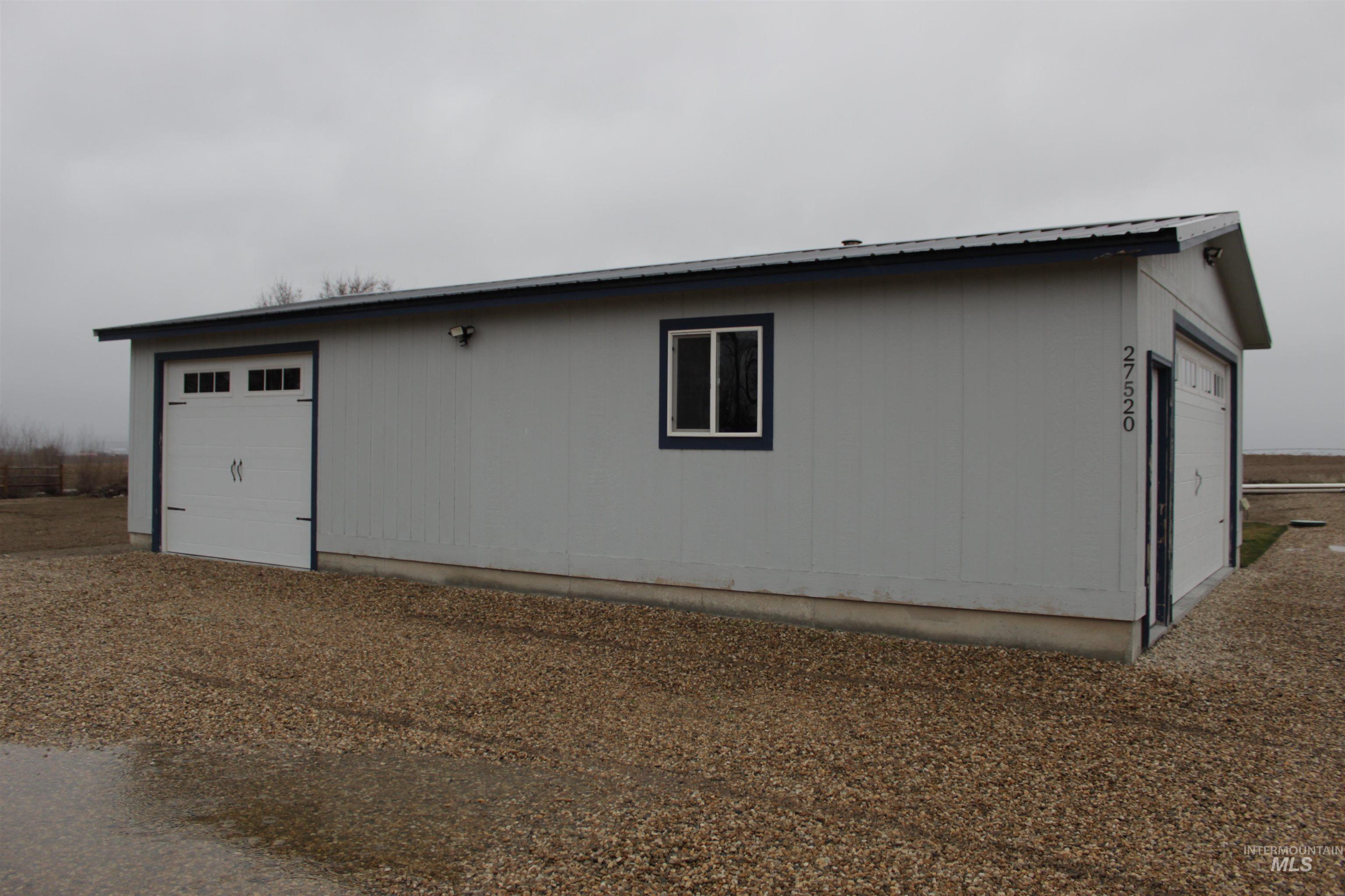 27520 Pearl Road Parma, ID 83660 - Photo 25 of 29 View of side of home featuring an outdoor structure and a metal roof