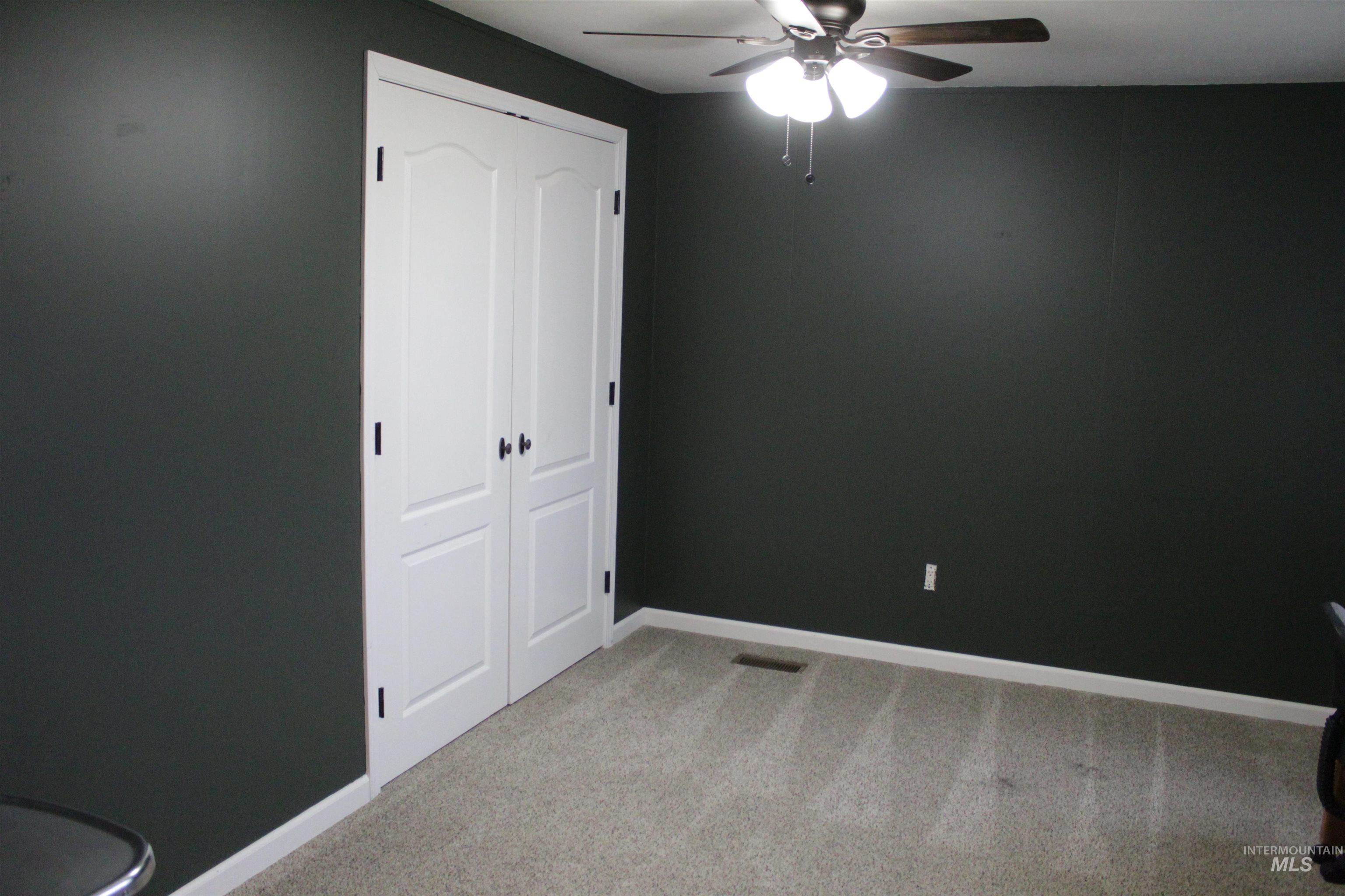 27520 Pearl Road Parma, ID 83660 - Photo 6 of 29 Unfurnished bedroom featuring light colored carpet, ceiling fan, and a closet