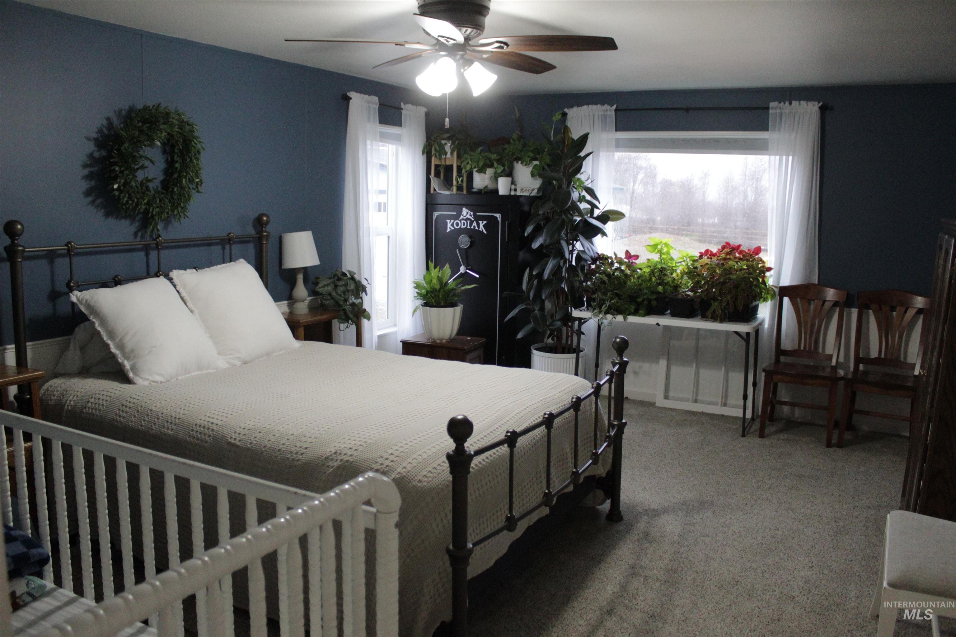 27520 Pearl Road Parma, ID 83660 - Photo 9 of 29 Bedroom with multiple windows, carpet floors, and a ceiling fan