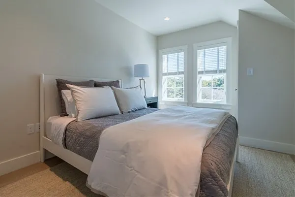 a bedroom with a bed and window