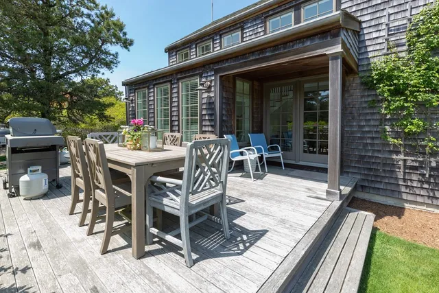 a view of a patio with table and chairs and potted plants