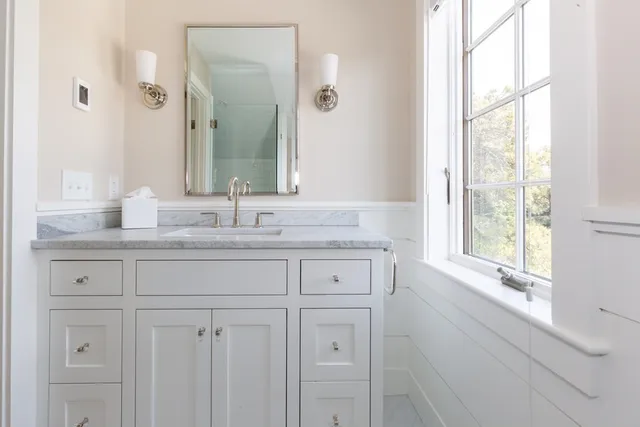 a bathroom with a sink and a large mirror