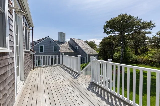 a view of balcony with wooden floor and fence