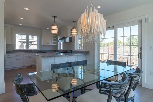 a kitchen with a table chairs and microwave