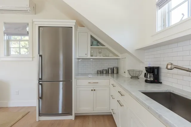 a kitchen with stainless steel appliances a refrigerator sink and cabinets