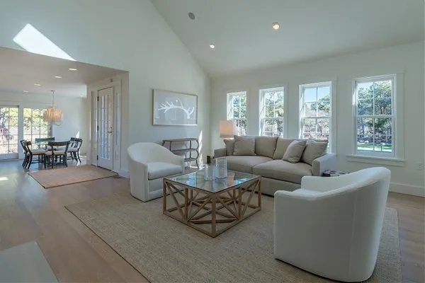 a living room with furniture and floor to ceiling windows