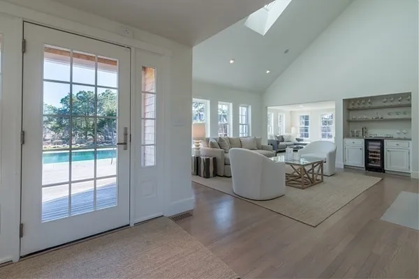a living room with fireplace furniture and a large window