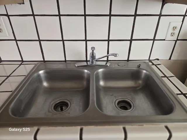 a kitchen with granite countertop white cabinets and stainless steel appliances