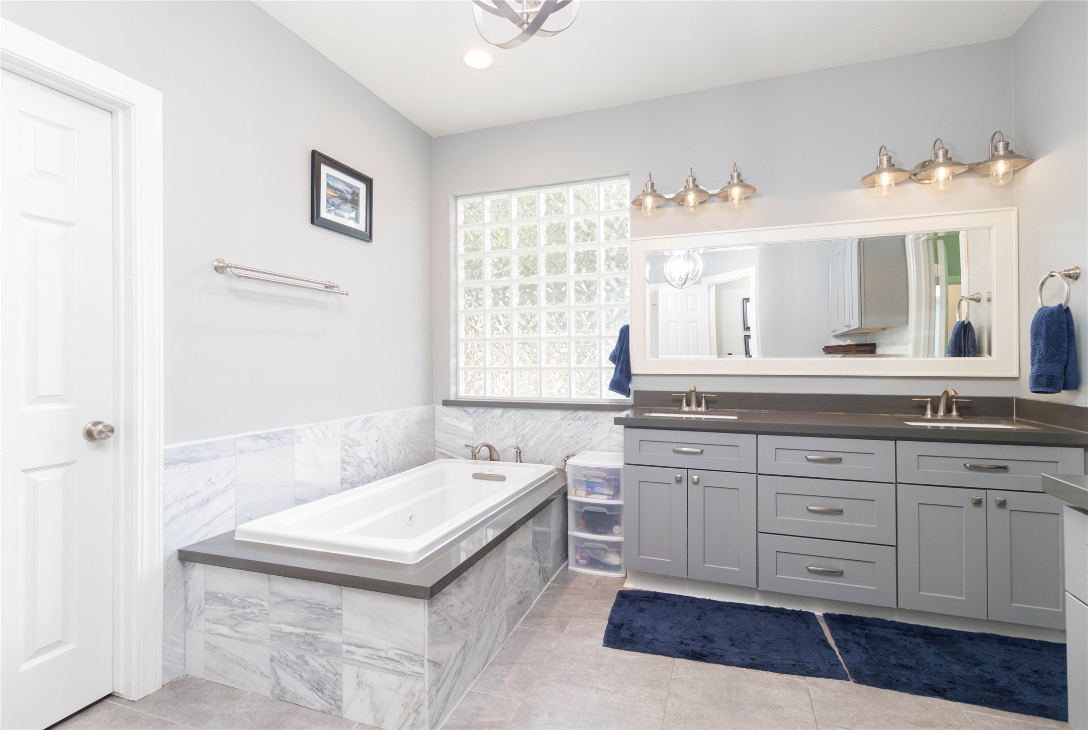 4515 Mulberry Park Lane Houston, TX 77345 - Photo 14 of 32 a spacious bathroom with a granite countertop sink a mirror and a bathtub