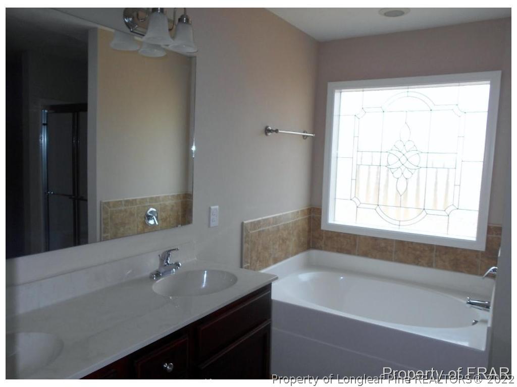 3140 Thrower Road Hope Mills, NC 28348 - Photo 17 of 23 a bathroom with a bathtub and a sink
