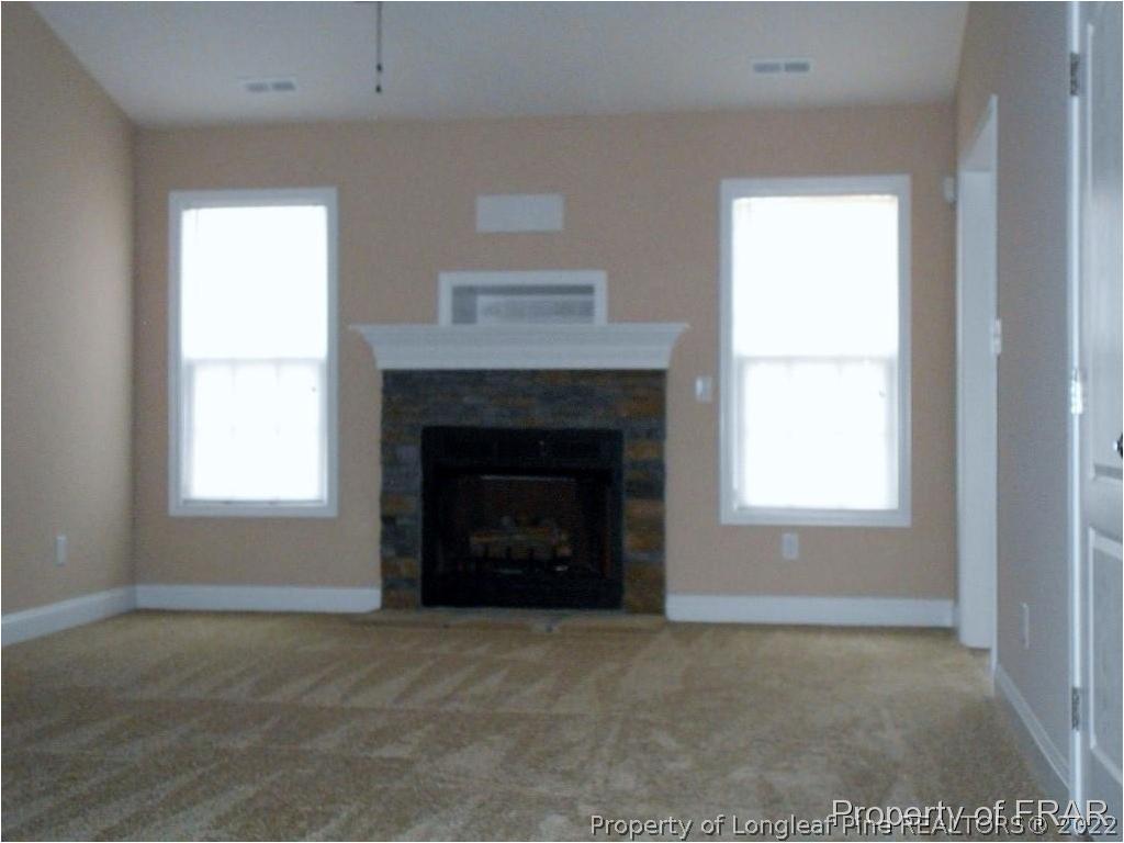 3140 Thrower Road Hope Mills, NC 28348 - Photo 3 of 23 a living room with a fireplace and a window