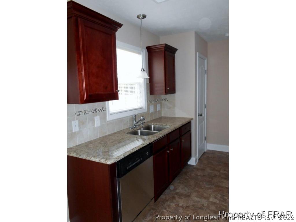 3140 Thrower Road Hope Mills, NC 28348 - Photo 6 of 23 a kitchen with a sink and a stove