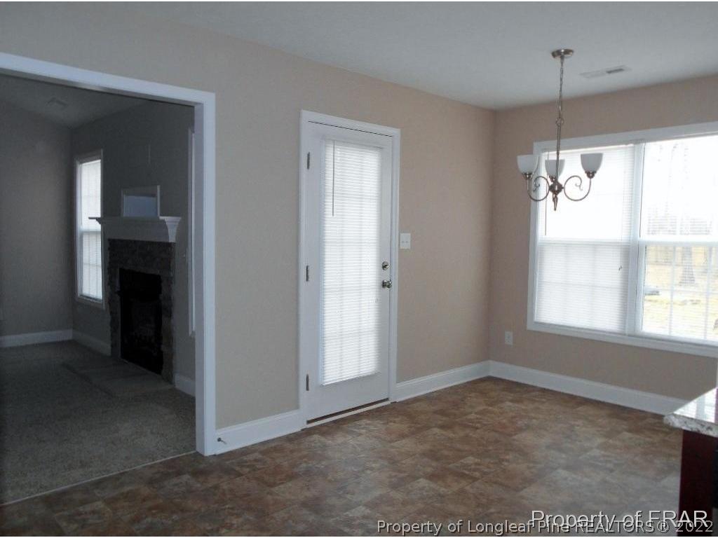 3140 Thrower Road Hope Mills, NC 28348 - Photo 8 of 23 an empty room with windows and chandelier