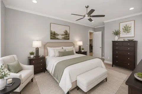 a spacious bedroom with a bed and painting on the wall