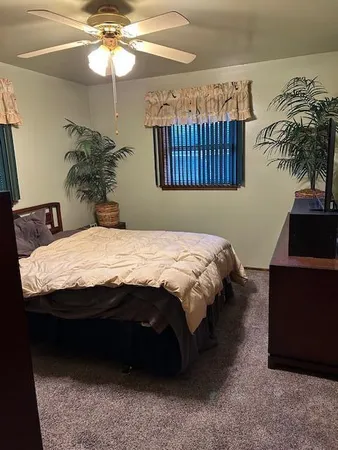 a bedroom with a bed and a chandelier